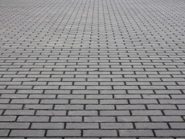 Gray brick paver driveway installed in a running bond pattern for residential property in Shaker Heights, OH