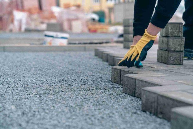 Driveway installation with pavers being placed on a gravel base for a residential property in Beachwood, OH