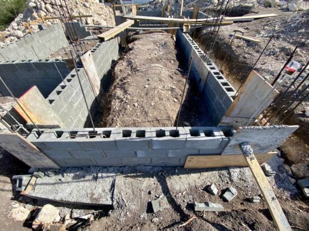 Concrete foundation installation with block walls and framing setup on the construction site in Shaker Heights, OH