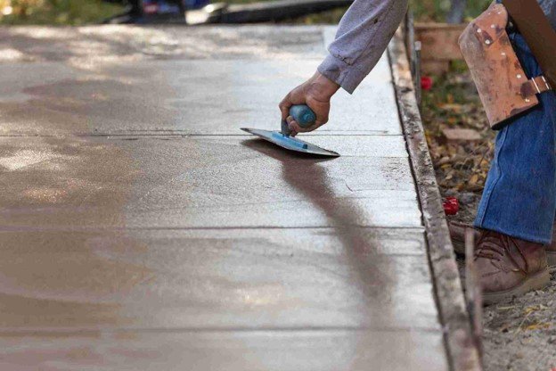 Newly installed concrete driveway with smooth finish and clean layout at residential home in Beachwood, OH